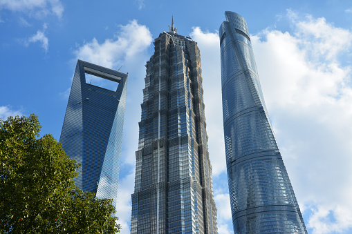 three high skyscrapers under blue sky in sunny day in Lujiazhui of Shanghai