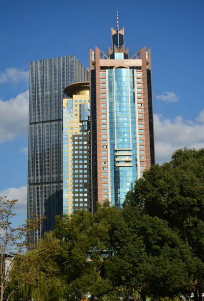 istock High skyscrapers behind the trees under the blue sky 1290065943