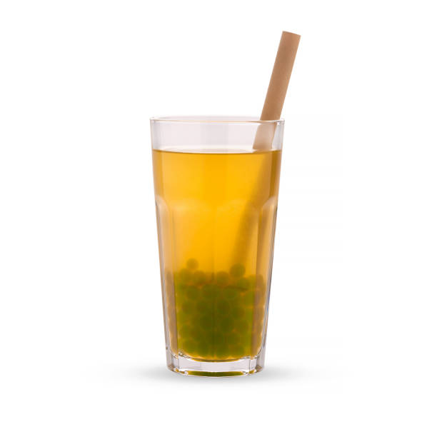 istock Yellow bubble tea with green tapioca pearls in glass beaker, isolated on white background. 1290067230