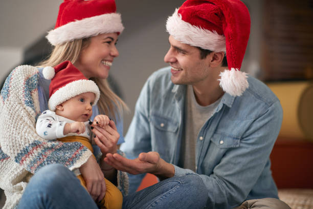 Joyful man and woman spending Chrismas together at home Joyful man and woman with baby spending Chrismas together at home mum new boyfriend stock pictures, royalty-free photos & images