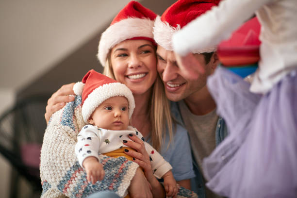 Joyful man and woman spending Chrismas together Joyful man and woman with baby spending Chrismas together mum new boyfriend stock pictures, royalty-free photos & images