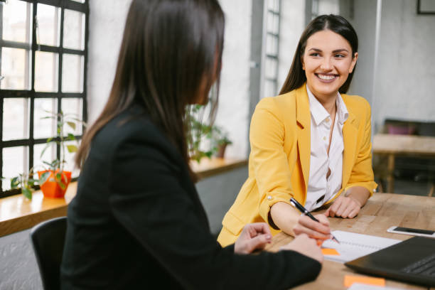 istock Female business colleagues discussing work in office 1290067638