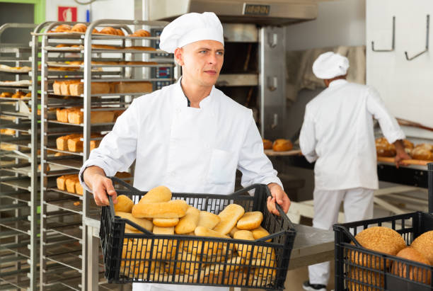 istock Portrait of baker with fresh bread at bakery 1290067792