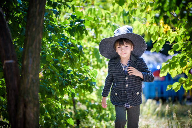 istock Toddler boy in pointed hat playing with magic wand outdoors. Little wizard. Halloween concept 1290068785