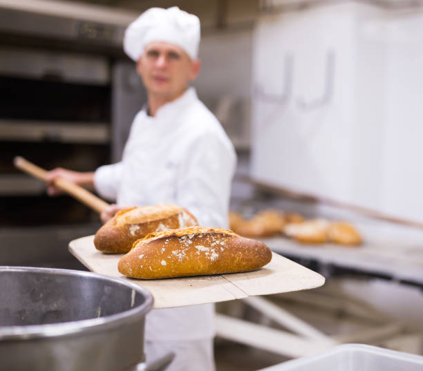 istock chef with ban bread on shovel in bakehouse 1290069039