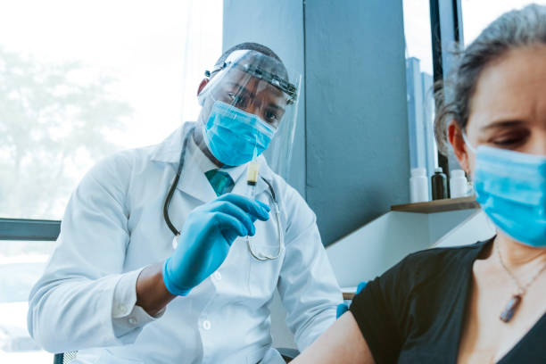 istock Doctor holding antidote injection by scared woman 1290069049