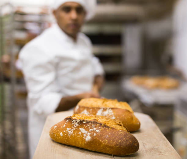 istock Freshly baked bread on peel in bakery 1290069059