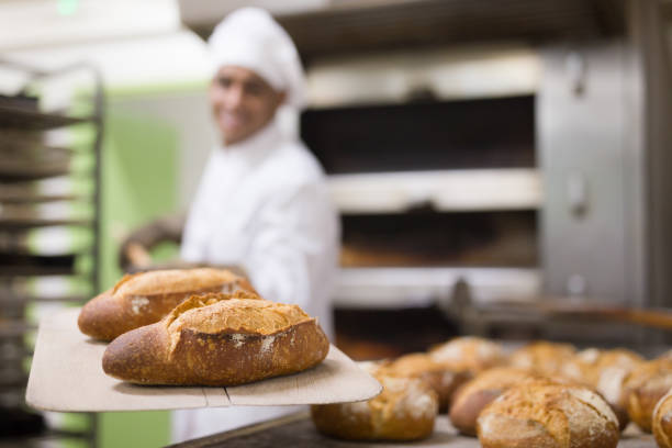 istock Freshly baked bread on peel in bakery 1290069091