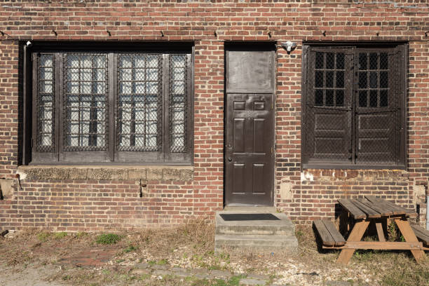 istock Red brick loft building with brown windows and doors on sunny day 1290069995
