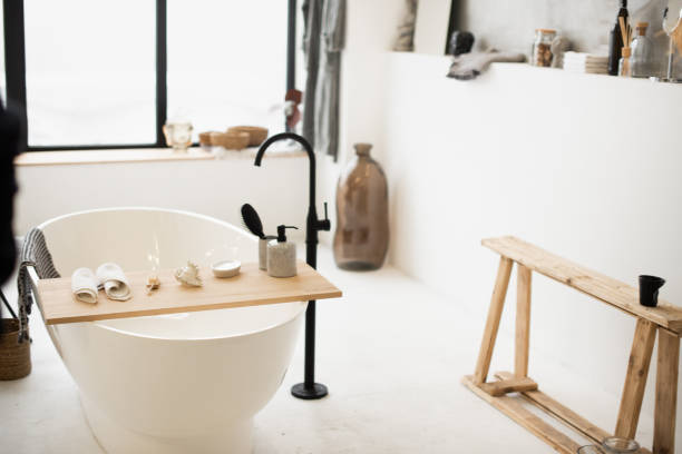 istock stylish white bathtub with decor opposite the window 1290070010