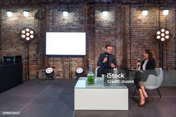 Businesswoman And Businessman During Presentation Stock Photo - Download Image Now - Stage - Performance Space, Interview - Event, Public Speaker