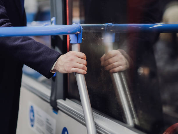 istock Selective focus on a passenger's male hand holding a handrail in a transport. 1290071406