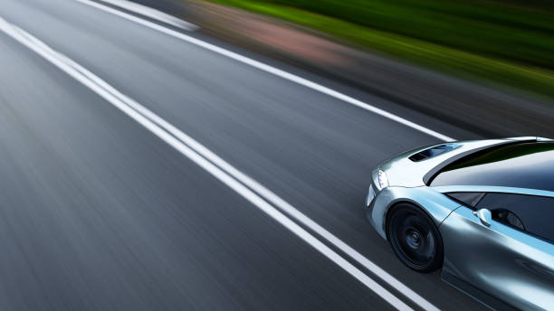 istock gray sportscar driving on a road 1290074132
