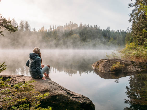 istock Woman contemplating mountain lake 1290074924