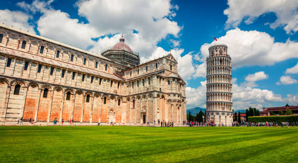 picturesque spring view of famous leaning tower in pisa. sunny morning scene with hundreds of tourists in piazza dei miracoli (square of miracles), italy, europe. traveling concept background. - cityscape pisa italy leaning tower of pisa imagens e fotografias de stock