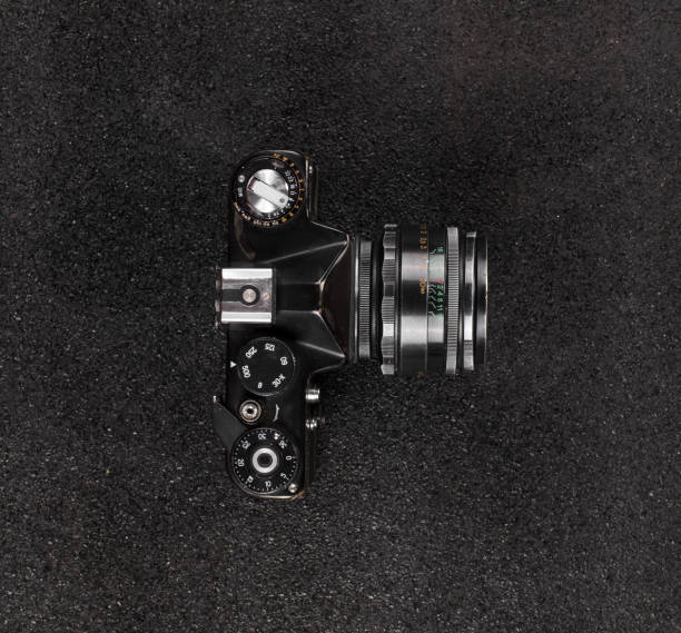 istock old vintage black camera on black background 1290077930