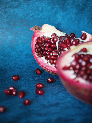 Close-up of fresh pomegranate fruit against pink background.