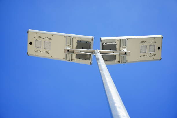 солнечная светодиодная лампа на фоне голубого неба - floodlight blue sky day стоковые фото и изображения