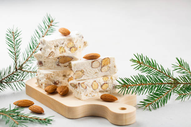 istock Torrone - soft italian nougat with almonds. Winter decoration. White background. 1290080466