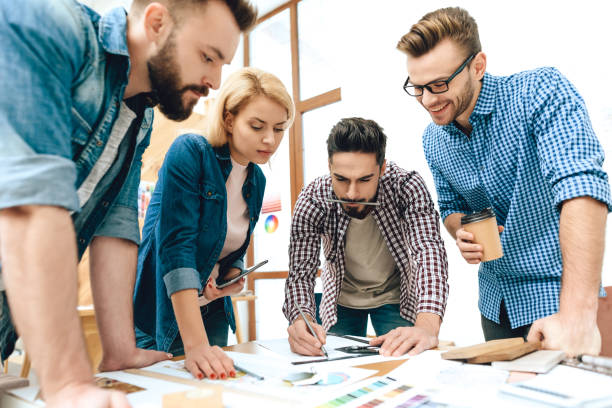 istock Team of designers architects discuss project. 1290080723