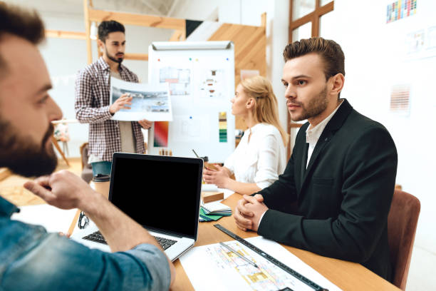 istock Team of designers architects watching presentation 1290080726