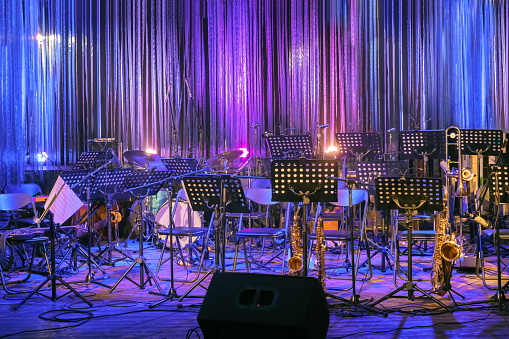 Musical Instruments and Equipment on Small Stage without People and Musicians. Concerts During Coronavirus Pandemic Covid-19. Illuminated Empty Stage for Orchestra. Online live Music. Online Event.