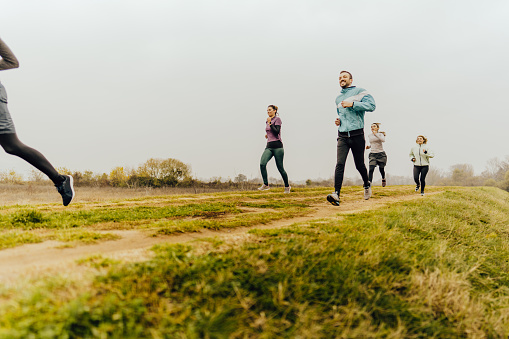 Photo of a group of young people running together with a support group