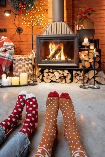 istock Couple in Christmas socks by the fireplace 1290084687