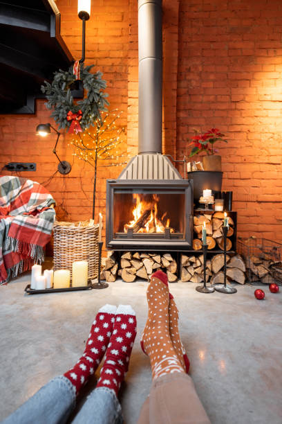 istock Couple in Christmas socks by the fireplace 1290084709