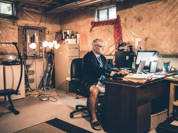 istock Mature man at work in his basement office 1290085278