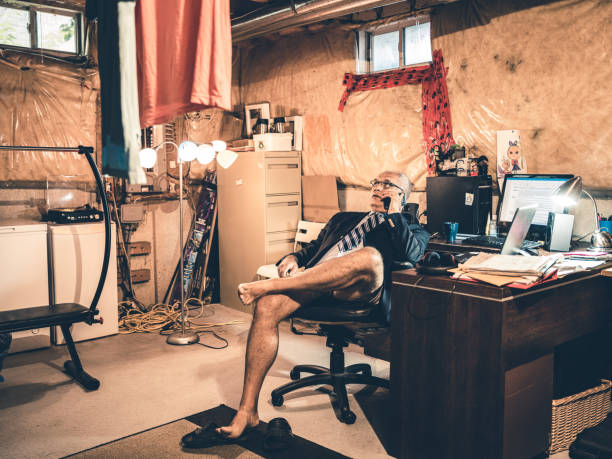 istock Mature man at work in his basement office 1290085397