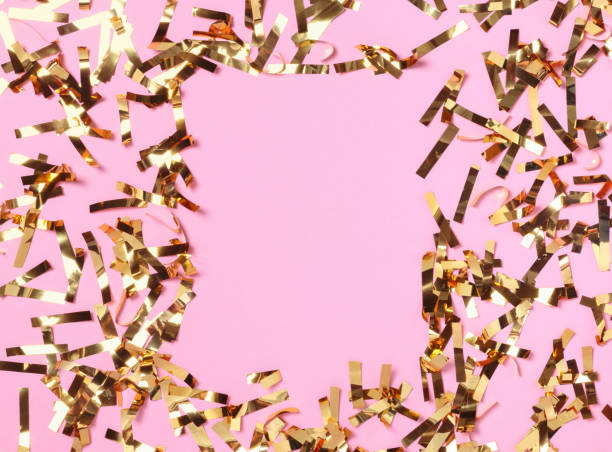 istock Party gold confetti on pink background. 1290087622