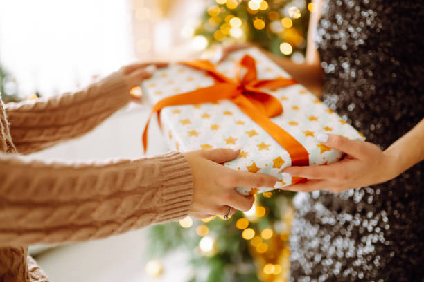 istock Gives the gift. Exchanging the christmas presen. 1290089332