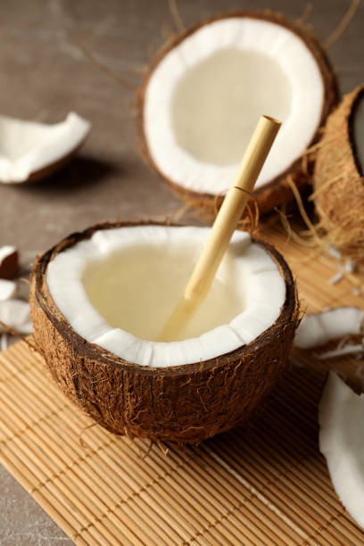 istock Tasty coconut with straw on bamboo background 1290090336