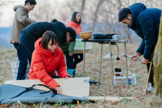 istock Group of friends preparing camping site 1290090741