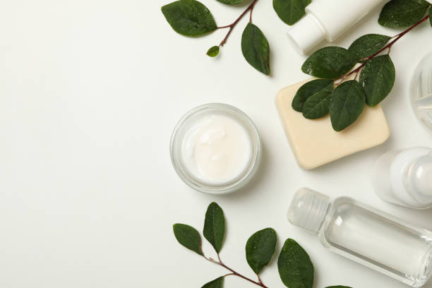 istock Spa cosmetic products and branches with leaves on white background, top view 1290092098