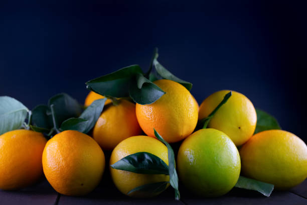 Ripe lemons on a black background