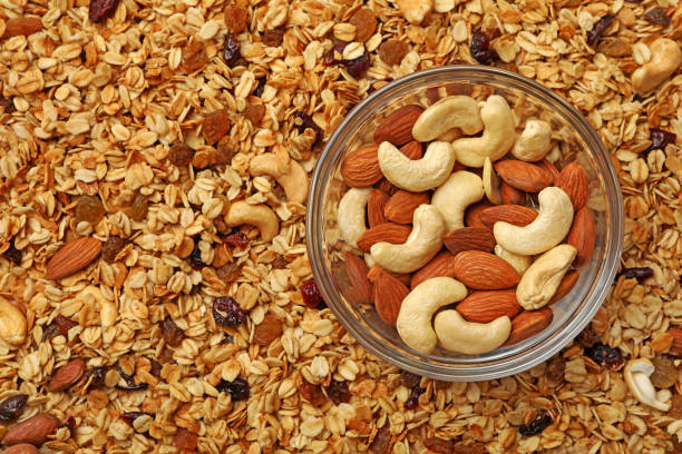 istock Bowl with nuts on granola background, space for text 1290094187