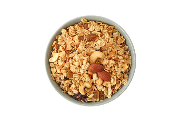 istock Bowl with tasty granola isolated on white background 1290094836