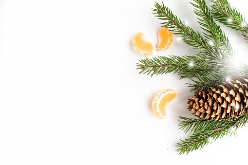 Christmas composition with spruce branches and tangerine, top view, copy space