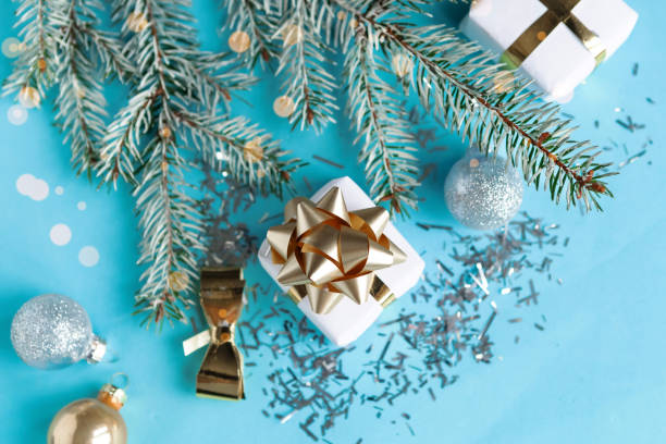 istock Christmas composition with gifts and decorations on blue background, top view 1290095526