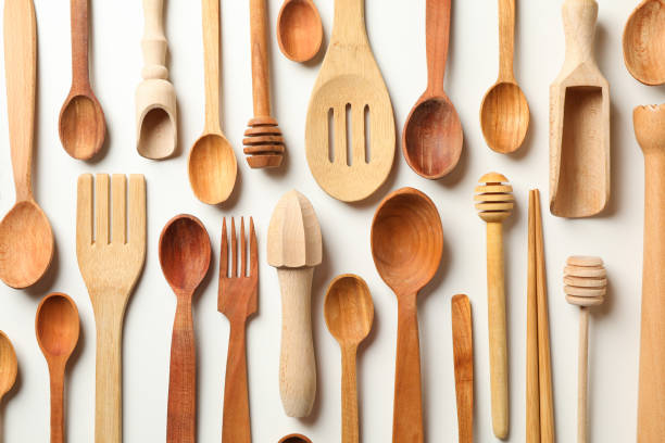istock Pattern of wooden dishes on white background 1290095787