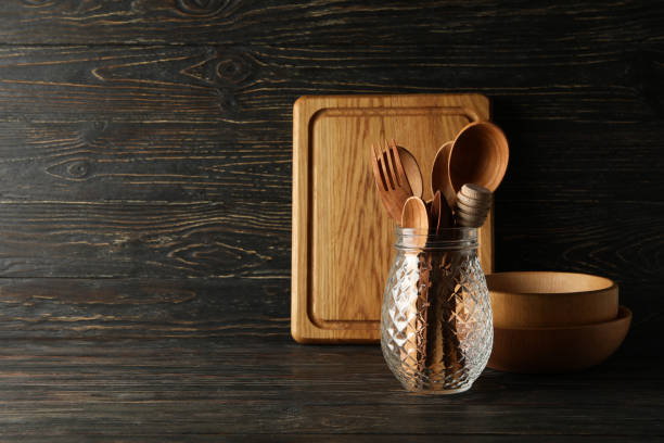 istock Different wooden kitchenware on wooden background, space for text 1290096032