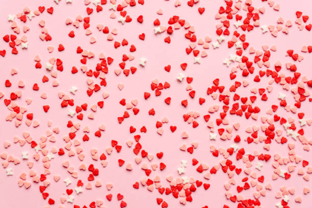 istock sprinkles background, sugar sprinkle red hearts, decoration for cake and bakery. Top view, flat lay. Valentines holiday 1290097656