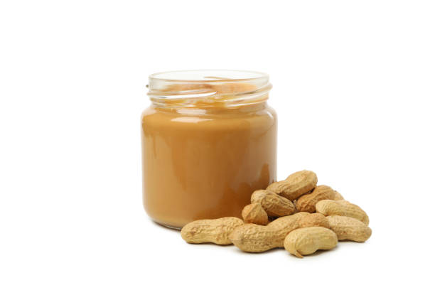 istock Peanut and jar with peanut butter isolated on white background 1290098901