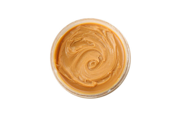istock Jar with tasty peanut butter isolated on white background 1290099010