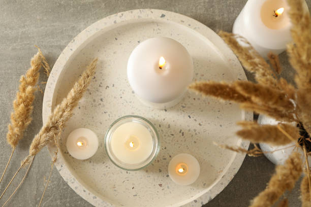 istock Tray with scented candles and reed on gray table 1290100594