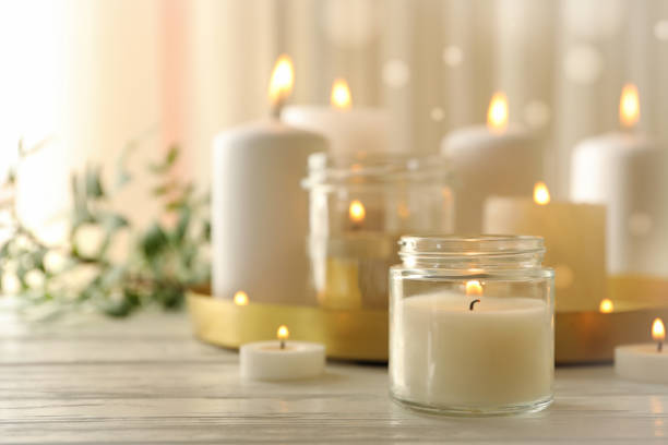 istock Burning scented candles for relax on white wooden table 1290101327