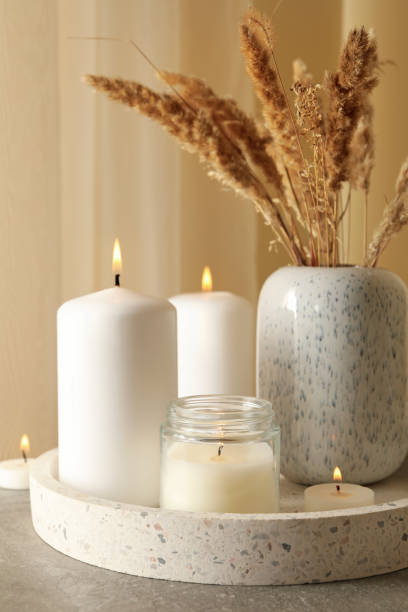 istock Tray with scented candles and reed on gray table 1290101610