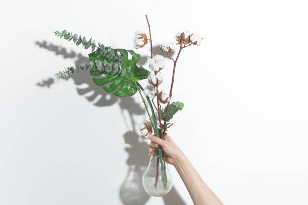 istock Dry and artificial flowers in a glass vase on a white background 1290102879